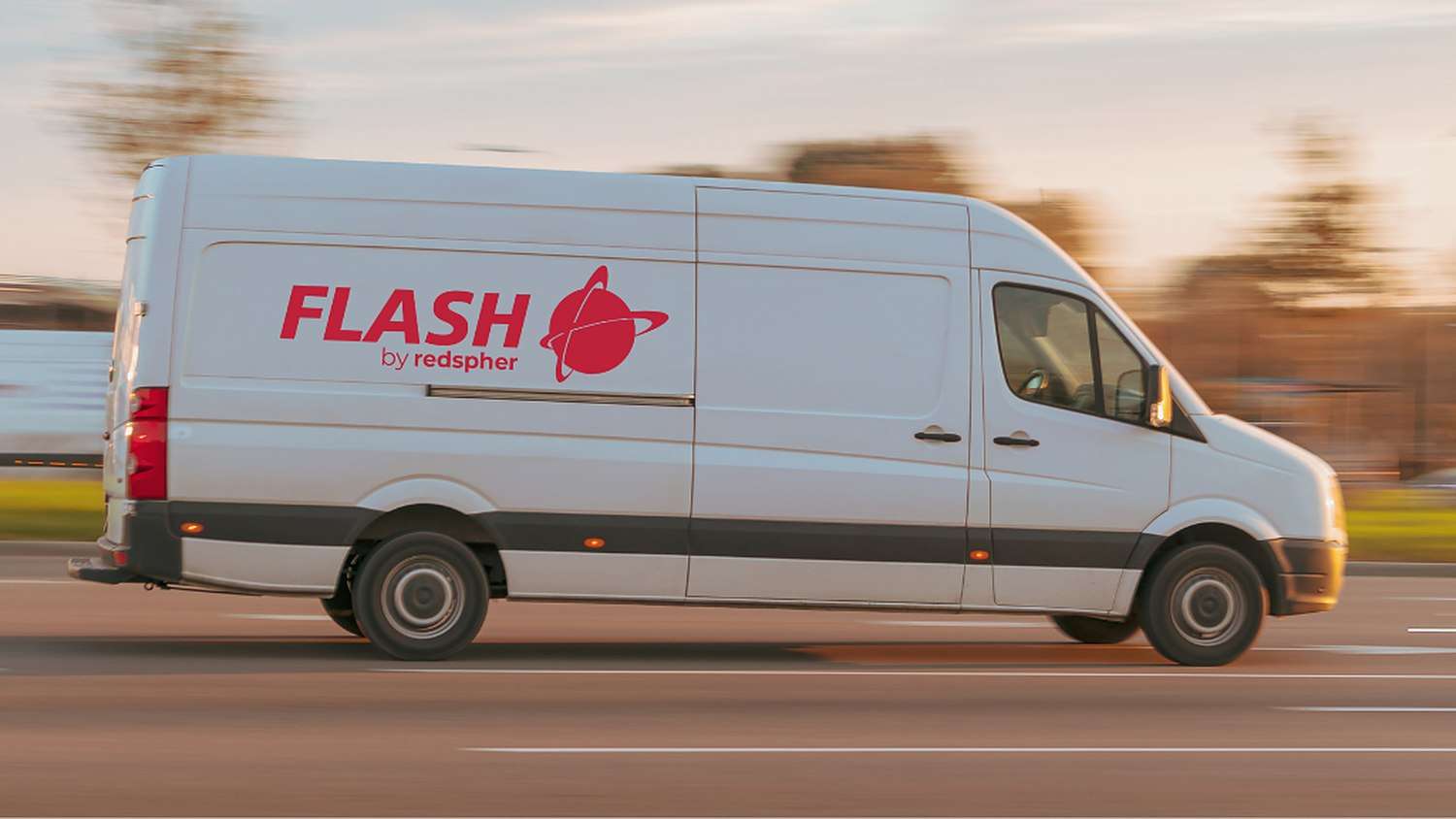 Flash by Redspher van in motion on the road at sunset